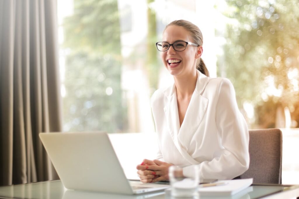 pexels-photo-3756679 Laughing businesswoman working in office with laptop